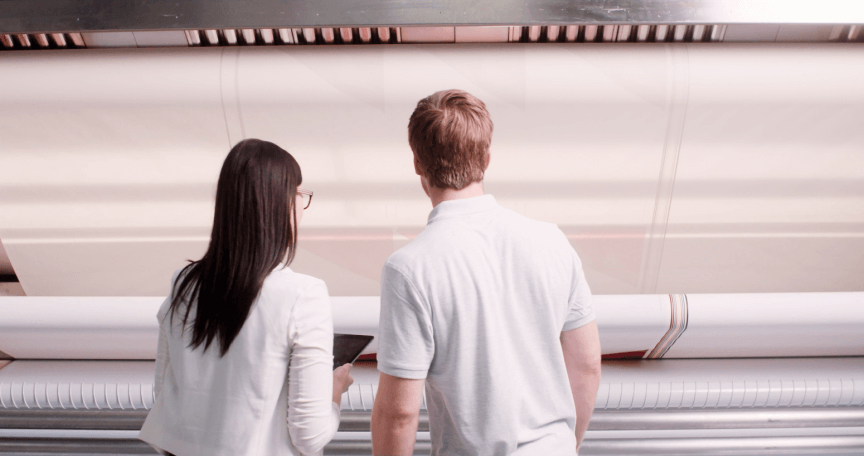 ARIAN employees monitoring fabric banner printing