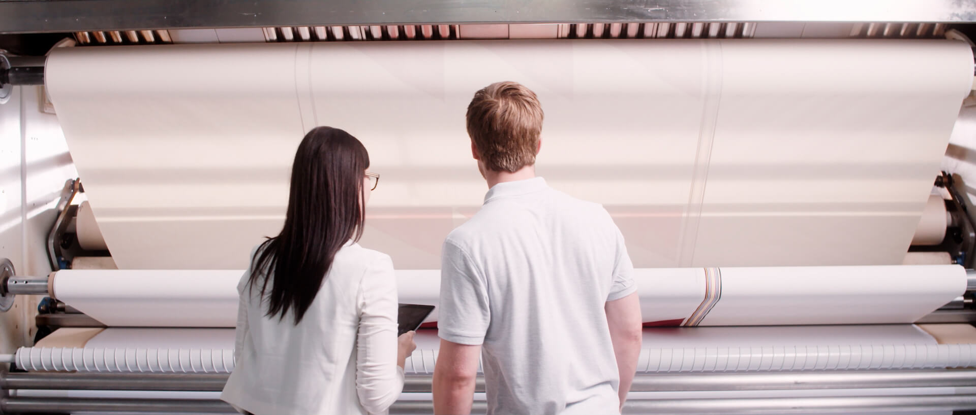 ARIAN employees observing fabric printing press