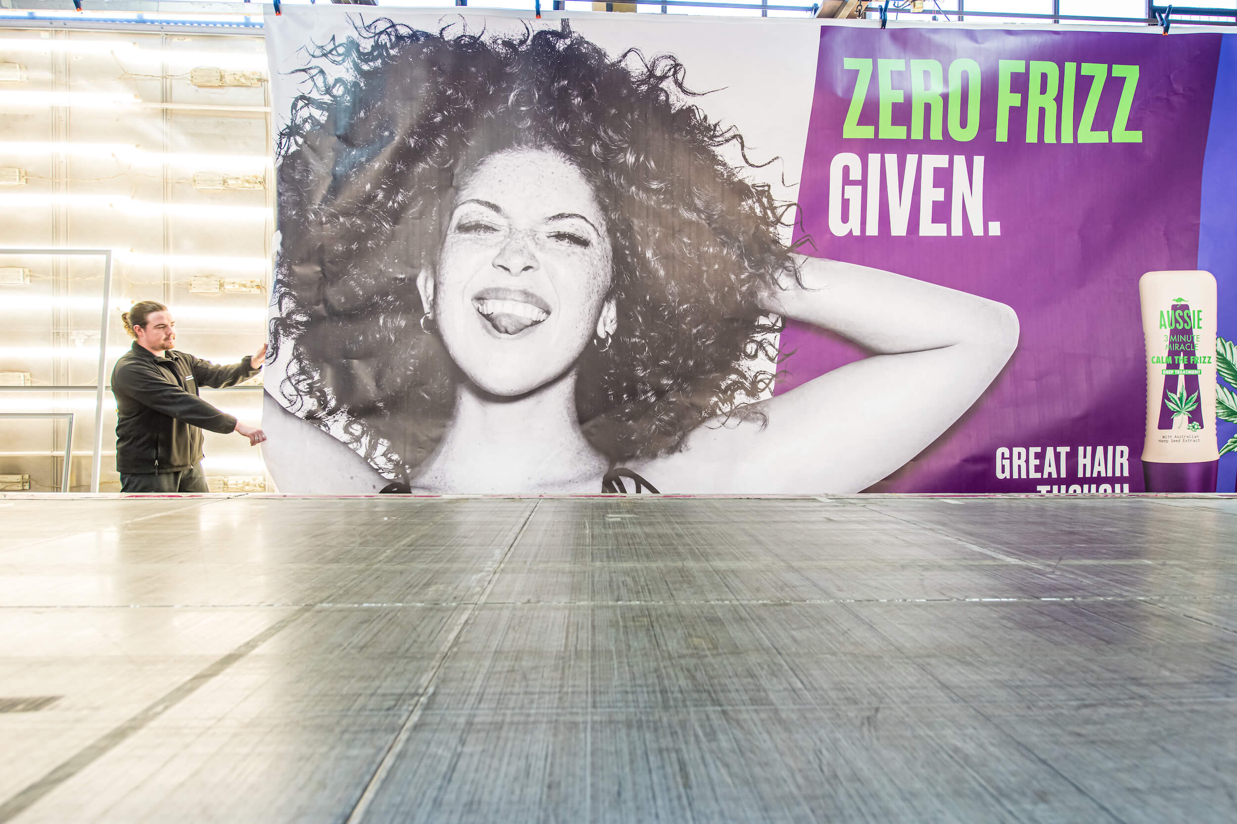 Large outdoor banner showing advertising for shampoo